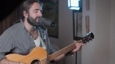 Young bearded attractive man singing in his studio - Close up shot