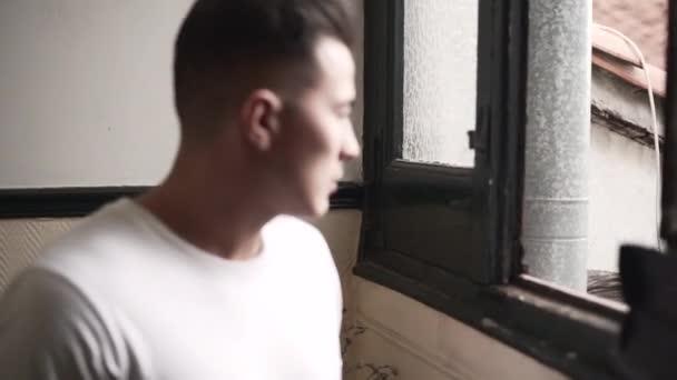Close Latino Young Man Looking Out Window Giving Serious Look — Vídeo de stock