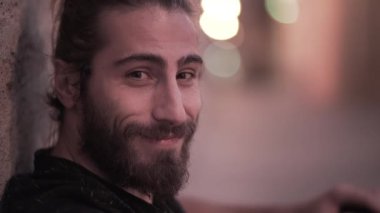 Close up of a young male having fun moving his eyebrows and laughing - Horizonal video