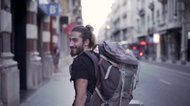 Young caucasian man turns around and open his arms in slow motion - Horizonal video