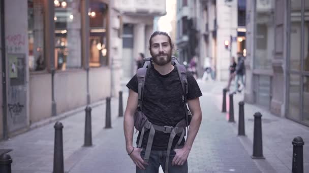 Attractive Backpacker Man Smiles Camera Hands Pockets Valencia Spain Slow — Αρχείο Βίντεο