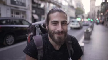 Close up of a happy young male smiling for the camera in slow motion - Horizonal video