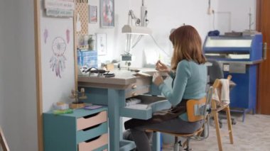 Female Artisan Is On Her Working Place Making Pet Jewels. Medium Shop 4K Horizontal video