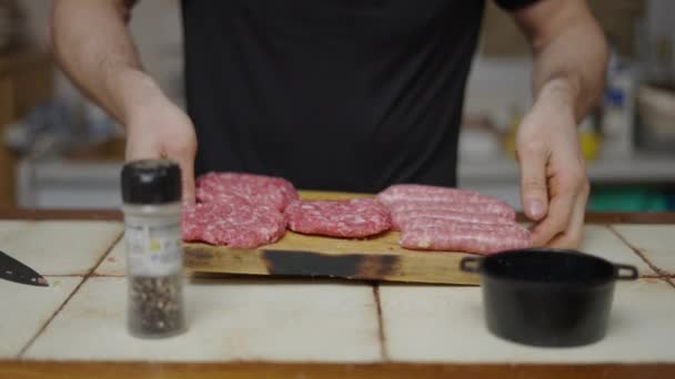 Chef Showing Seasoned Burgers Sausages Cutting Board Slow Motion Horizontal — Video Stock