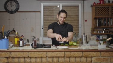 Young barman rims cocktail glass with sugar recording a video tutorial - 4K Horizontal video