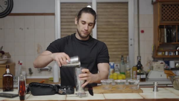 Young Male Using Cocktail Strainer Pour Beverage Cocktail Glasses Horizontal — Stok video