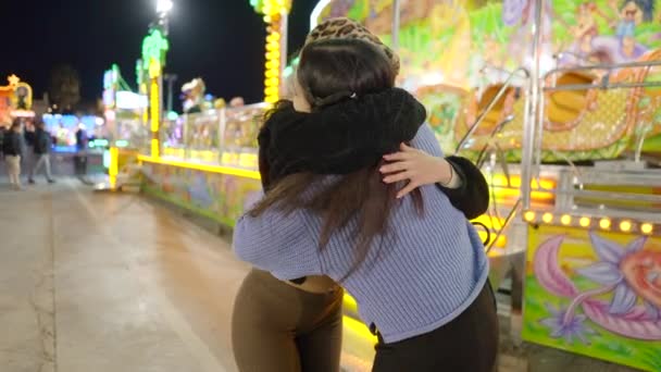 Two Female Friends Hugging Each Othe Outdoor Funfair Night Slow — Vídeos de Stock