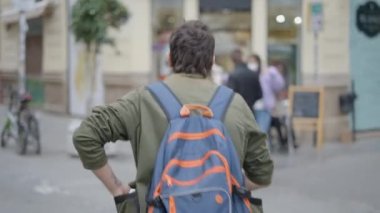 Back view of man walking towards the public to show magic tricks . - 4K Horizontal video