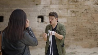 Consummate mastery of magician. The magician shows a trick with a rope. Magician performing trick with rope. Magic performer illusionist, disappears and rises. - 4K Horizontal video