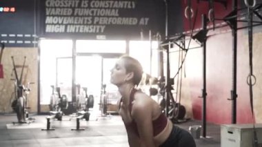 Young athletic woman doing kettle bell snatch exercise - Horizontal video