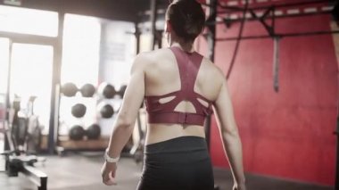 Fitness woman walking to get gym equipment in slow motion - Horizontal video