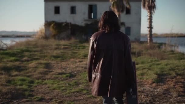 Spanish Musician Carrying His Guitar Case Walking Abandoned House Rural — ストック動画