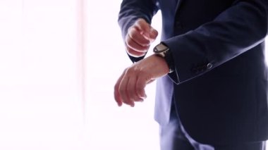 Husband in blue suit fixing his sleeves. Close up shot - Horizontal Video