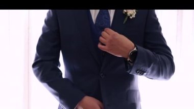 Groom getting his blue suit on point for the wedding - Horizontal Video