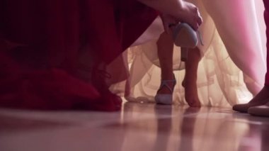 Bride getting her shoes put on before the ceremony - Horizontal Video