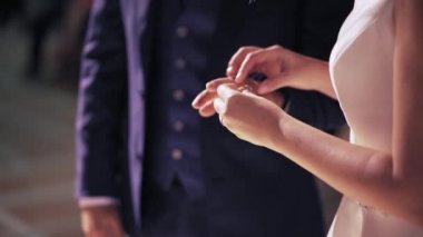 Bride exchanging wedding ring with groom - Horizontal Video