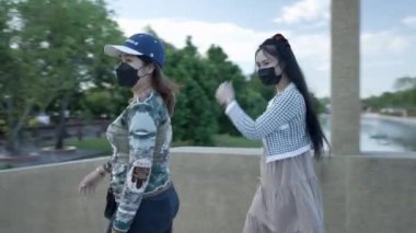 Thai girls in respiratory masks visiting the temple during covid-19 coronavirus pandemic in Ayutthaya - 4K Horizontal