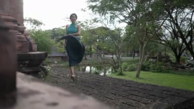 A Female Tourist Elegantly Swirling Her Skirt Within Heritage Museum In Thai Ban Mai, Thailand. Slow-motion - 4K Horizontal video