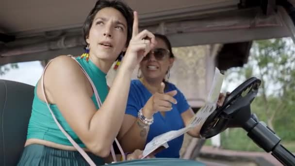 Two Excited Tourists Female Friends Sitting Golf Cart Searching Direction — Stockvideo