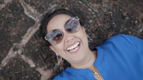 Female Tourist Blue Shirt Sunglasses Smiling While Lying Old Concrete — Vídeos de Stock