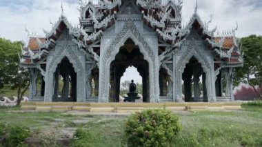 Woman Meditating Inside Temple In Bangkok Thailand - wide shot - 4K Horizontal video