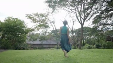 Carefree Woman On The Garden Meadows At The Park Of Ancient City In Bangkok, Thailand. Wide Shot - 4K Horizontal video