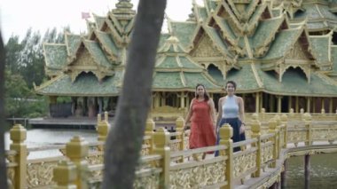 Women Walking In A Bridge In The Ancient City of Muang Boran In Bangkok, Thailand - medium shot - 4K Horizontal video