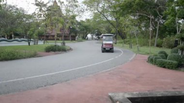 Two Female Tourists Friends Enjoying A Golf Cart Tour Ride Around The Museum Park In Ancient City Muang Boran, Samut Prakan Province In Thailand. - Medium Shot - 4K Horizontal video