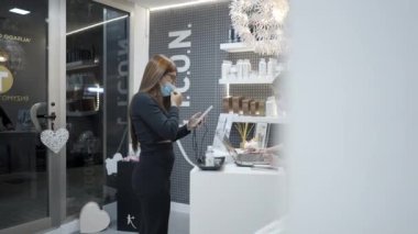 Girl using face ID to unlock phone and pay service at the hair salon - 4k Horizontal video