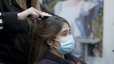 Colombian girl getting hair ready for treatment at hairdresser - 4k Horizontal video