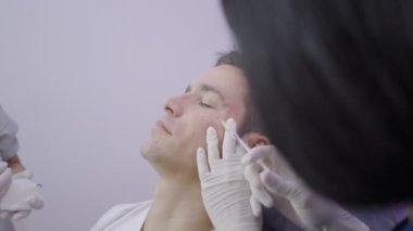 Handsome man getting mesotherapy treatment in beauty salon in Bangkok - 4K Horizontal video