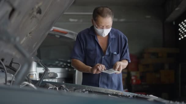 Skilled Auto Mechanic Fixing Broken Car Engine Garage Medium Shot — Stockvideo