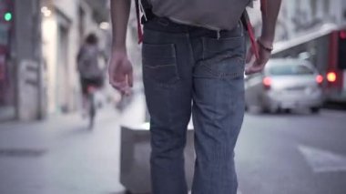 Close-up of backpacker dirty feet hanging out around the city and having fun - Horizonal video