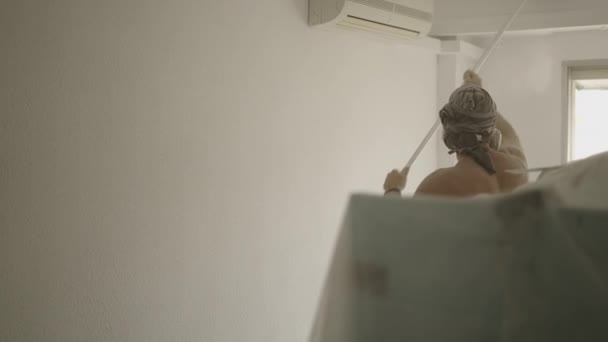 Арендатор Дома Вытирает Пыль Недавно Сглаженной Стены Метлой Горизонтальное Видео — стоковое видео
