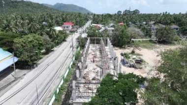 Tayland 'da yol boyunca inşaat alanında çalışan adamlar. İnşaat konsepti. Hava Aracı - 4K Yatay Video