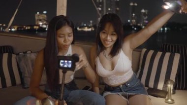 Genç arkadaşlar restoran incelemesini aksiyon kamerasıyla çekiyor, kız telefon feneri tutuyor - 4K Yatay Video
