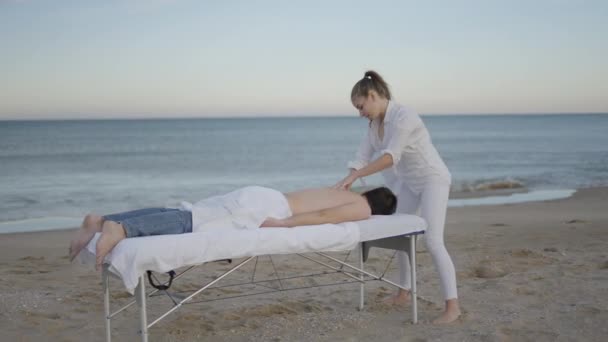 Szerokie Ujęcie Kobiety Robiącej Relaksujący Masaż Młodemu Mężczyźnie Przy Specjalnym — Wideo stockowe
