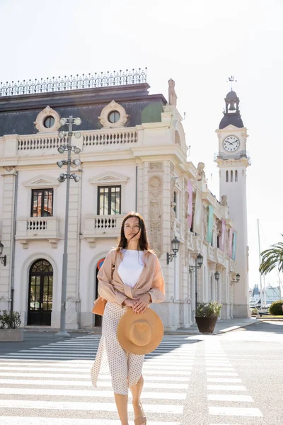 Trendy Woman Straw Hat Standing Street White Building Clock Tower — 스톡 사진