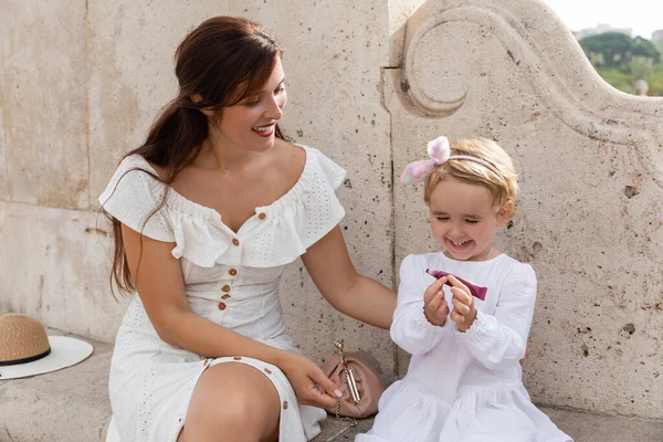 Positive Mom White Dress Looking Toddler Child Holding Lip Gloss — Foto de Stock