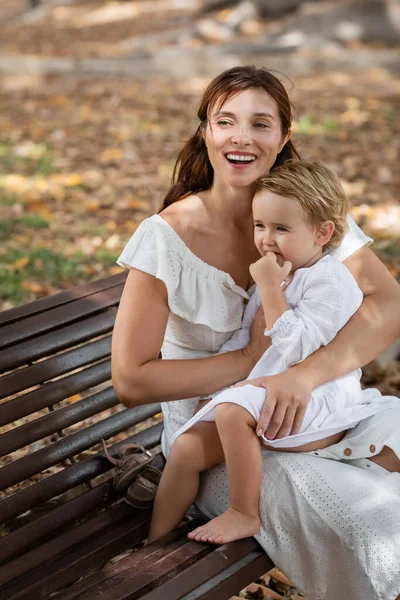 Brunette Woman Hugging Toddler Girl Summer Dress Bench Park — Photo