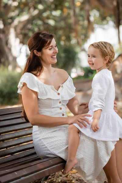 Positive Mother Dress Looking Baby Daughter Wooden Bench Park — Fotografia de Stock
