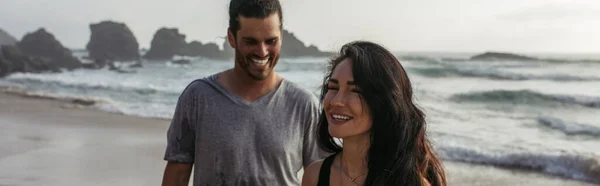 ポルトガルのビーチで陽気なボーイフレンドの近くで笑顔の幸せな女性バナー — ストック写真