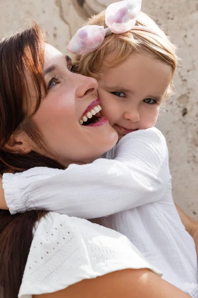 Portrait of baby girl hugging smiling mother outdoors in Valencia — Stock Photo