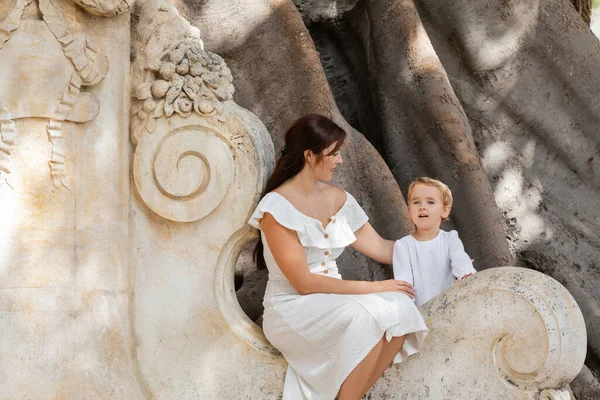Woman looking at daughter near tree in park in Valencia — Stock Photo