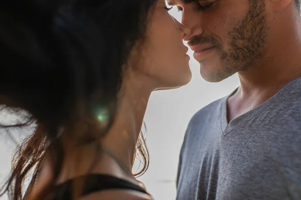 Partial view of bearded man and brunette woman kissing outside — Stock Photo