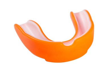 orange sports mouth guard, protection of teeth in box of rubber on white background