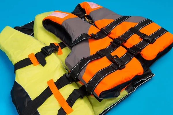 Two Colored Life Jackets Blue Background Concept Saving Life Water — Φωτογραφία Αρχείου