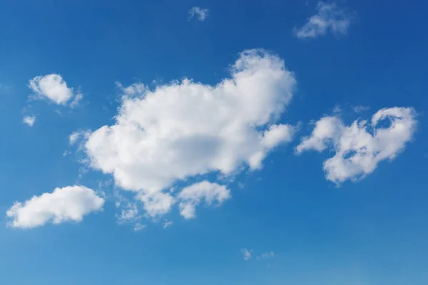 A large cloud in the center and a few small clouds on the edges of the plot, in the blue sky