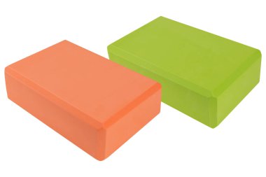 two colored yoga blocks, green and orange, on a white background, isolate