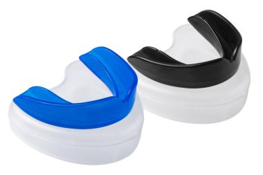 two boxing shields, blue and black, lie on plastic cases, protection of teeth and lips, on a white background, isolate